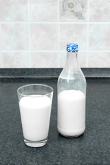 Bottle of milk and a glass of milk on the table