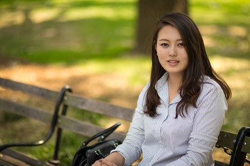 Fototapeta na wymiar Young Asian woman in city smile happy face portrait
