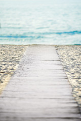 wooden trail to the sea on a beach