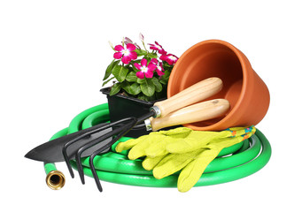 Garden tools and flowers with fork and gloves isolated on white