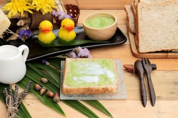 Bread with green custard and fresh milk.