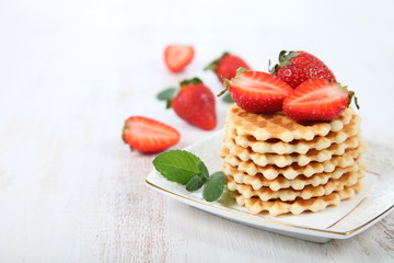 Waffles and ripe strawberries.