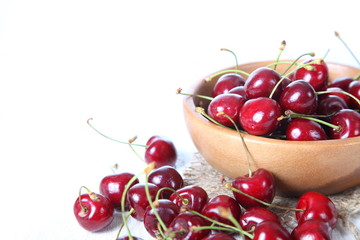 Ripe cherry in a wooden bowl