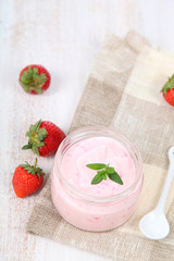 Fototapeta na wymiar Strawberry yogurt and ripe strawberry
