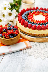 Raspberry and blueberry cheesecake on wooden table
