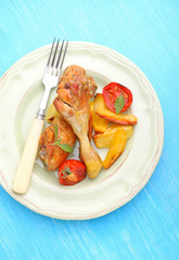 baked chicken legs with potatoes and tomatoes