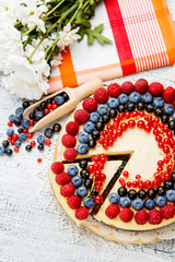 Raspberry and blueberry cheesecake on wooden table