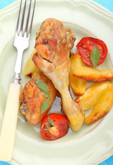 baked chicken legs with potatoes and tomatoes