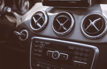 A modern and luxury car cockpit. Vintage filter. Selective focus.