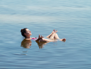The lake with salt water. Baskunchak . Beautiful woman sunbathin