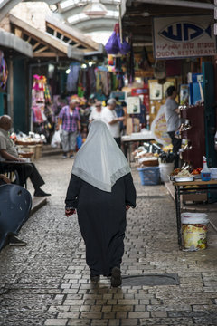 woman strolling in market in Acre, Israel