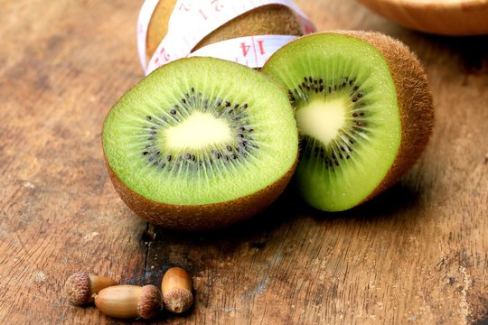 fresh kiwi fruit and tape measure