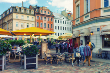 Naklejka premium Outdoor cafe with flowers in the old town. Blurry