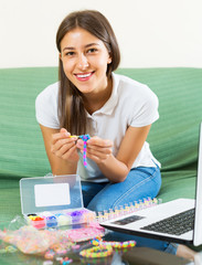 Woman makes braslets with elastic