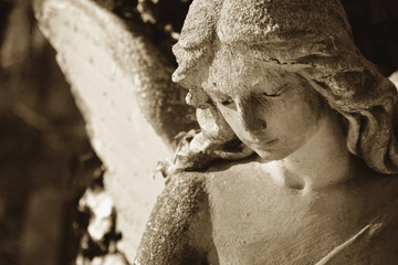 Vintage image of a sad angel on a cemetery