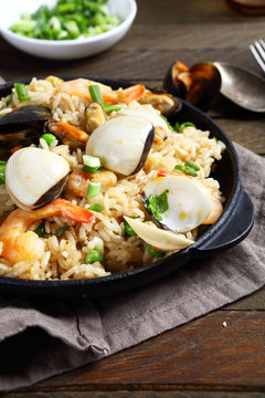 Rice with shrimp and mussels in a frying pan