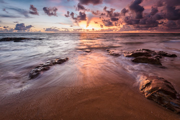 sea waves lash line impact rock on the beach