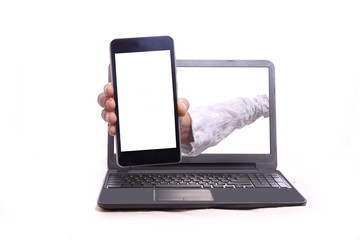 Woman showing mobile phone from inside the laptop
