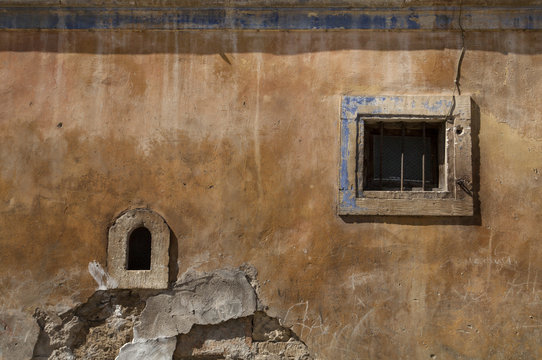 old  window on old yellow wall