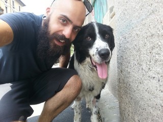 bearded man and his friend pet dog outdoor in the street taking selfie