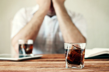Fototapeta na wymiar glass of whiskey with cola on a wooden table