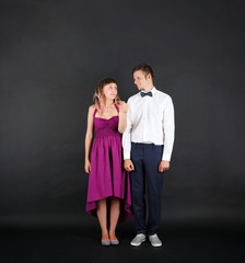 Emotional young couple on black background