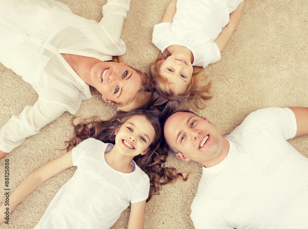 Poster parents and two girls lying on floor at home