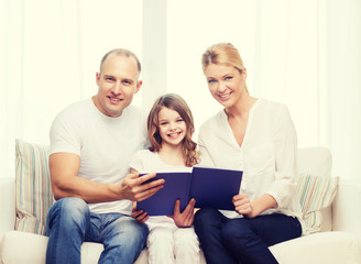 Fototapeta premium smiling parents and little girl with at home