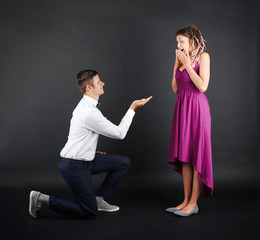 Young couple on black background