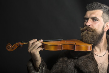 Man in fur coat with violin