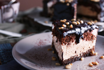 Delicious chocolate cake with icing in plate on table, closeup