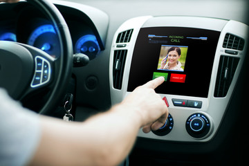 male hand receiving video call on car panel screen