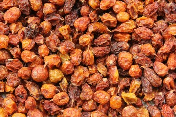 Bright orange and yellow dried sea buckthorn (Hippophae rhamnoides) berries close-up. A healthy snack and alternative herbal medicinal product. Perennial shrub.