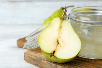 Pear juice with fresh fruit and cinnamon on table close up
