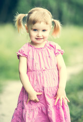 Cute little girl on the meadow 