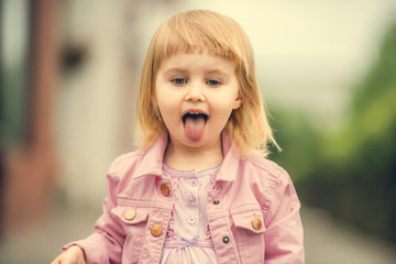 Beautiful girl showing tongue close up