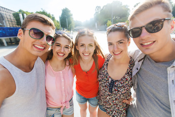 smiling friends taking selfie