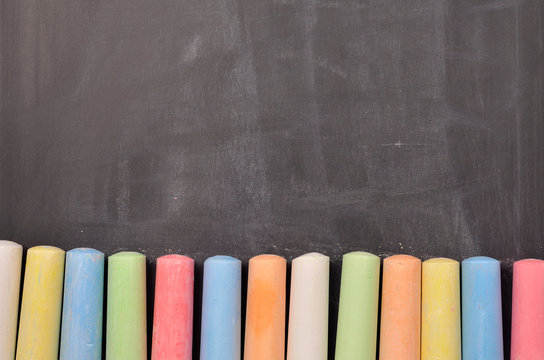 Colorful chalk on blackboard
