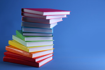 Colorful books on blue background