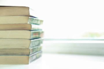 Books on white windowsill, close up