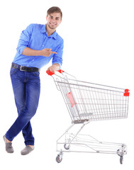 Young man with empty shopping cart, isolated on white