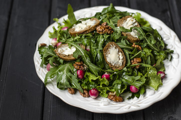 Radish salad with arugula and walnuts bruschetta with goat cheese  
