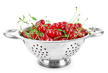 Cherries in colander isolated on white