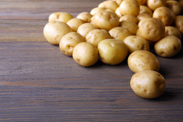 New potatoes on wooden background