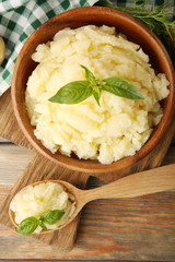 Mashed potatoes in bowl on wooden table, top view