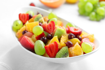 Fresh fruit salad on white wooden table