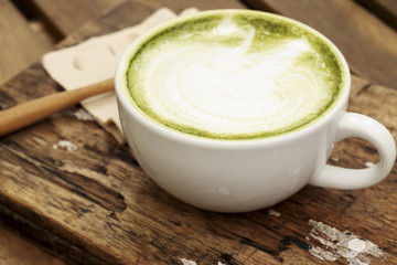 Hot mocha coffee decorated on wooden background, latte art.
