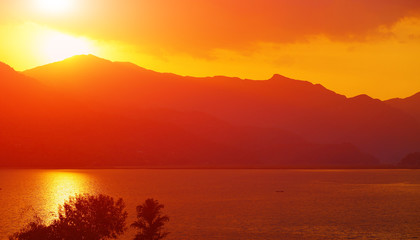calm evening landscape with lake and mountains