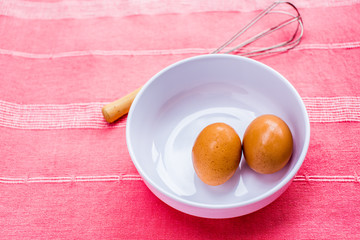 preparing omelet with eegs and whisk