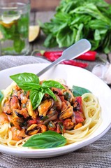 pasta with mussels, pepperoni, bacon, tomato and basil